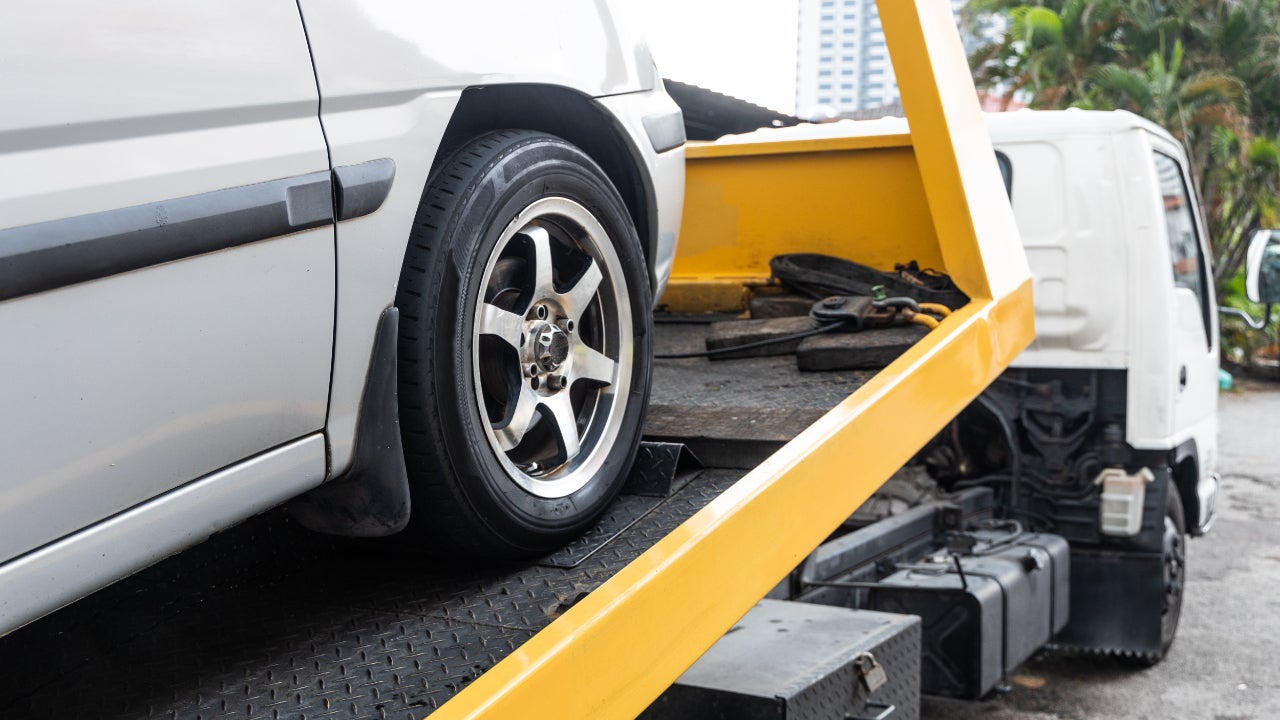 Close up of silver car on tow truck bed