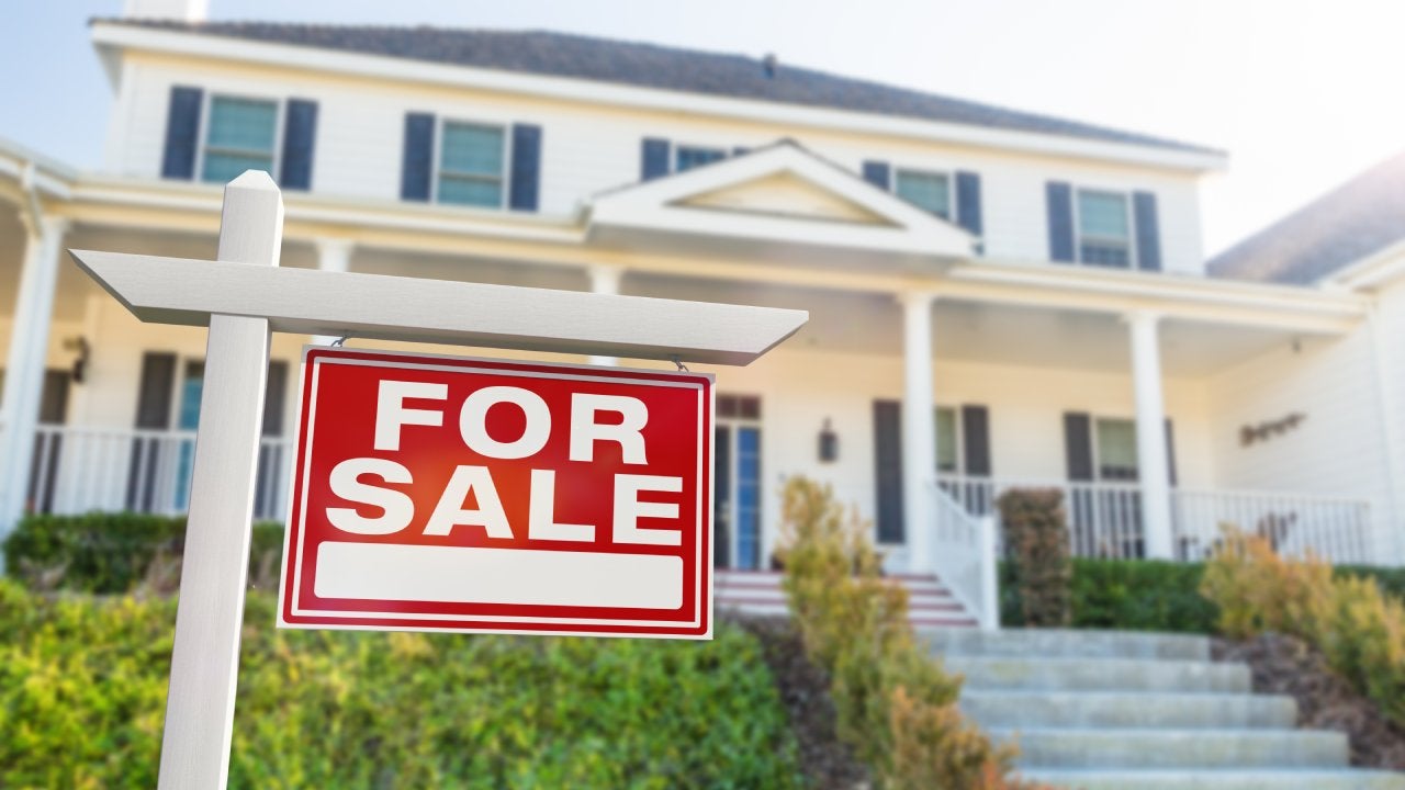 For Sale Real Estate Sign in Front of New House.