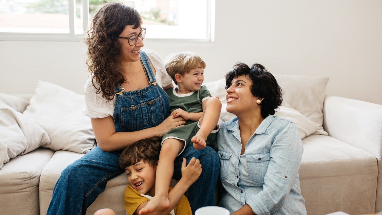 Two moms play with children