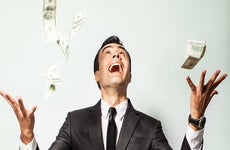Man in suit excited about money falling © KieferPix/Shutterstock.com