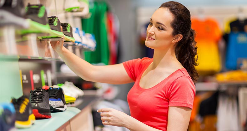 Woman checking out sneakers in store © michaeljung/Shutterstock.com