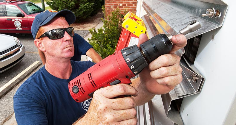 Installing hurricane shutters | PAUL J. RICHARDS/Getty Images