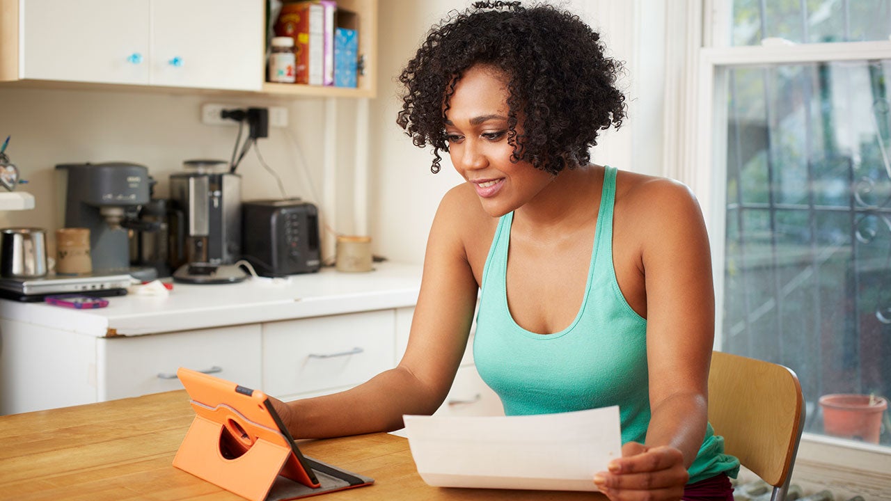 Woman looking at loan on tablet