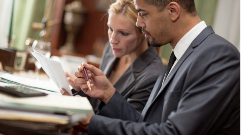 Lawyers examine paperwork together