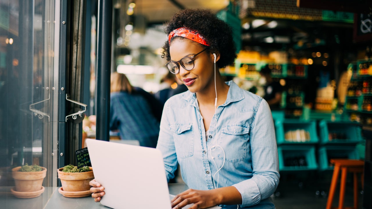 A young woman works on her laptop.