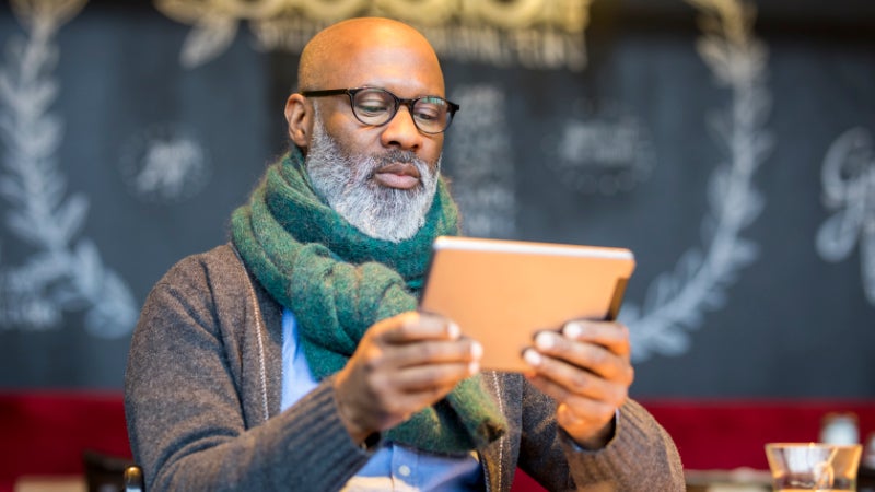 Man using tablet in coffee shop