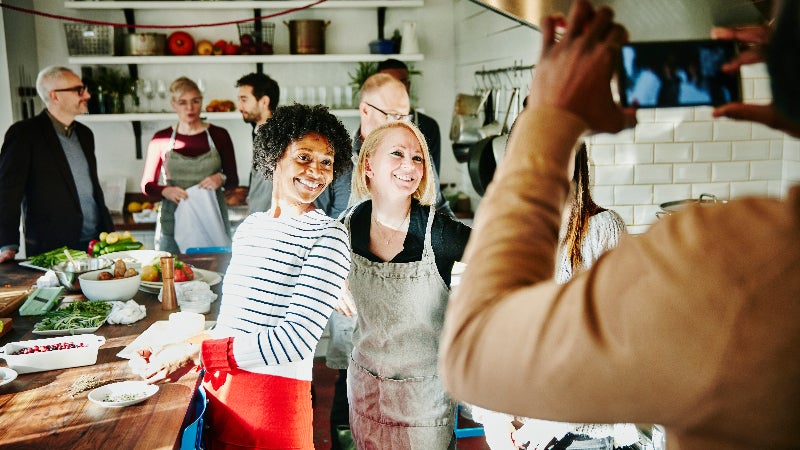 Group of friends in the kitchen at a holiday party