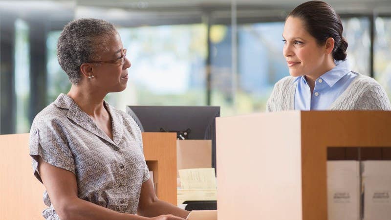 Woman at bank talking to teller