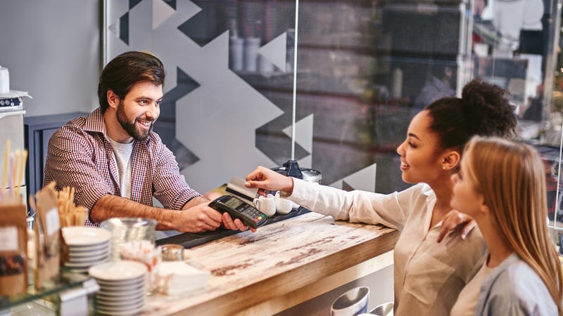 Woman pays for coffee with credit card