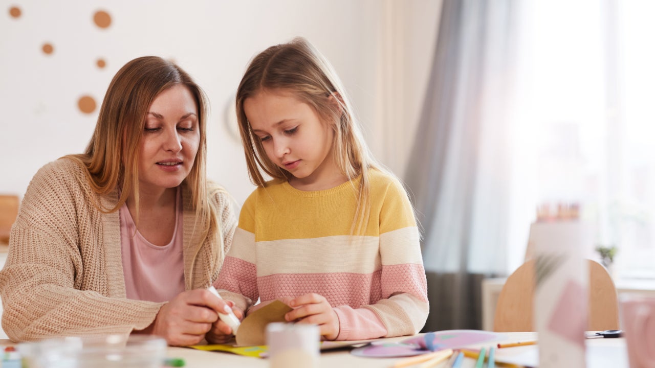 A white mother plays with her daughter