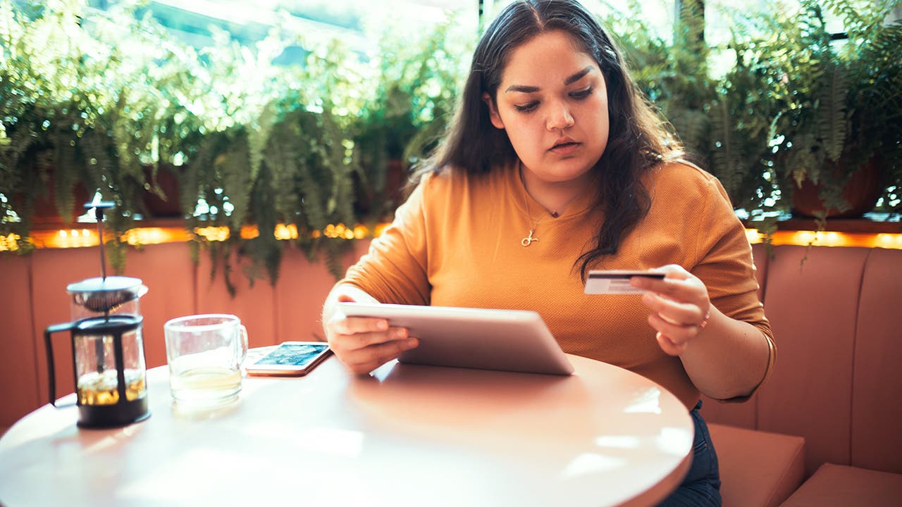 woman shopping online with a credit card