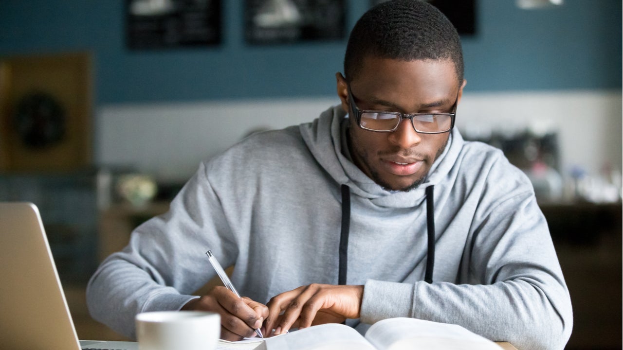 Student works on homework at coffee shop.