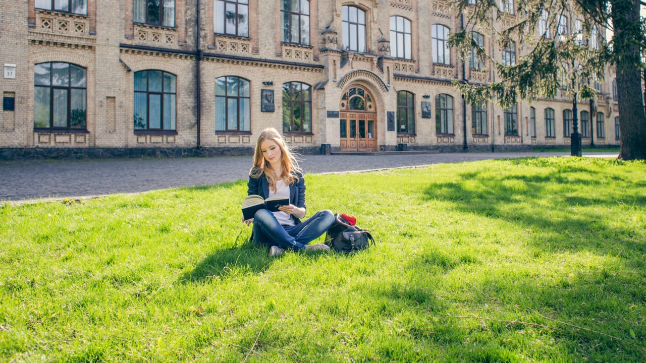 Young woman studies on college campus.