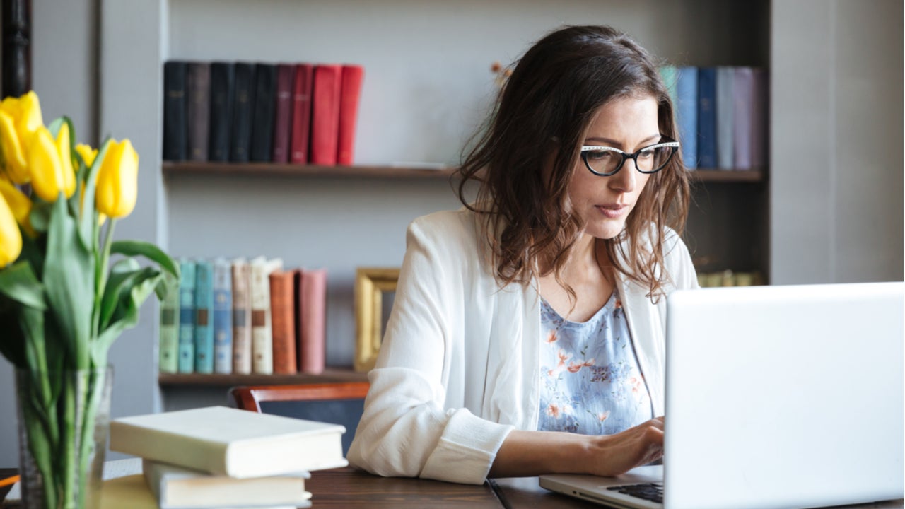 Woman looks over finances on computer.