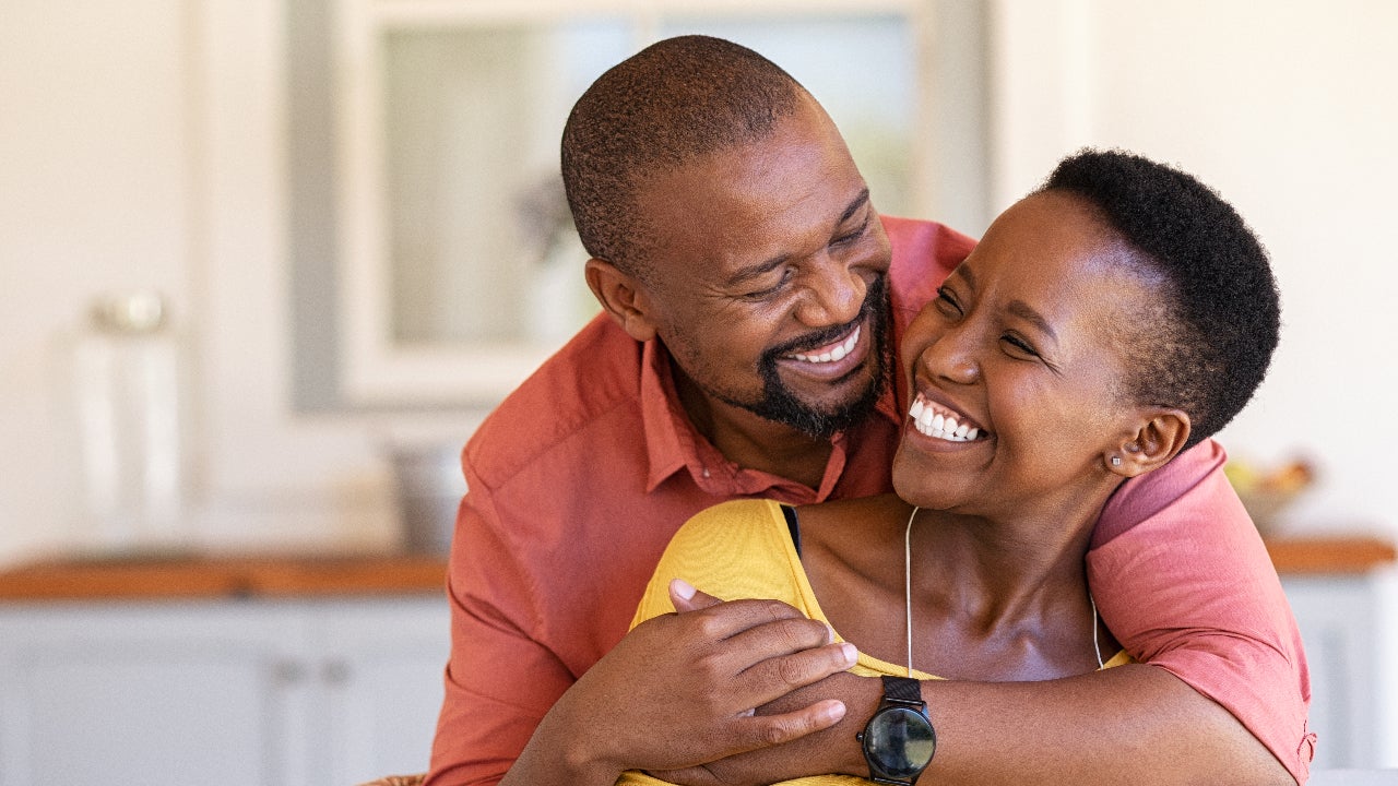 A middle age Black couple hugs each other