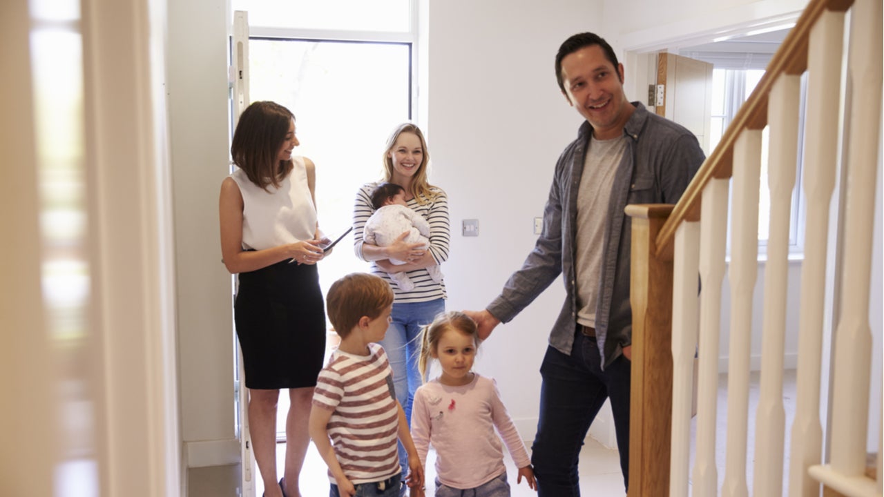 A real estate agent gives a tour of a home