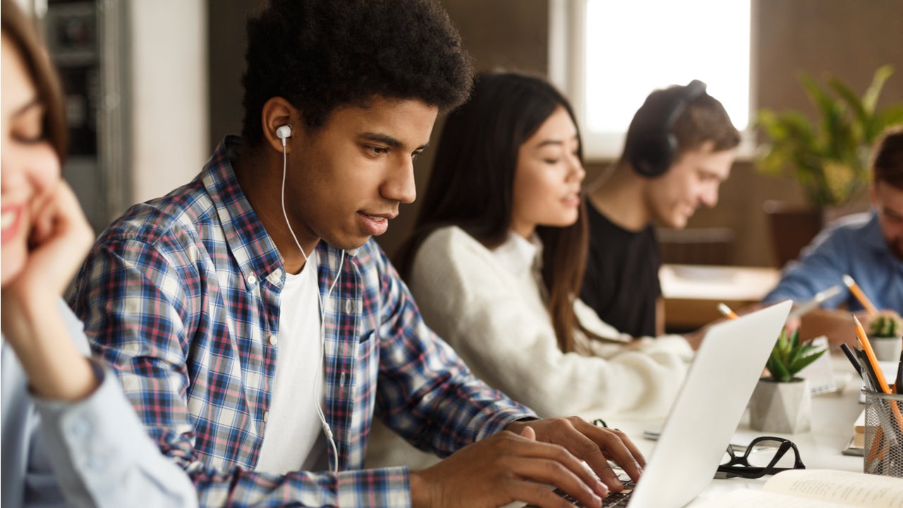 High school students study on laptops