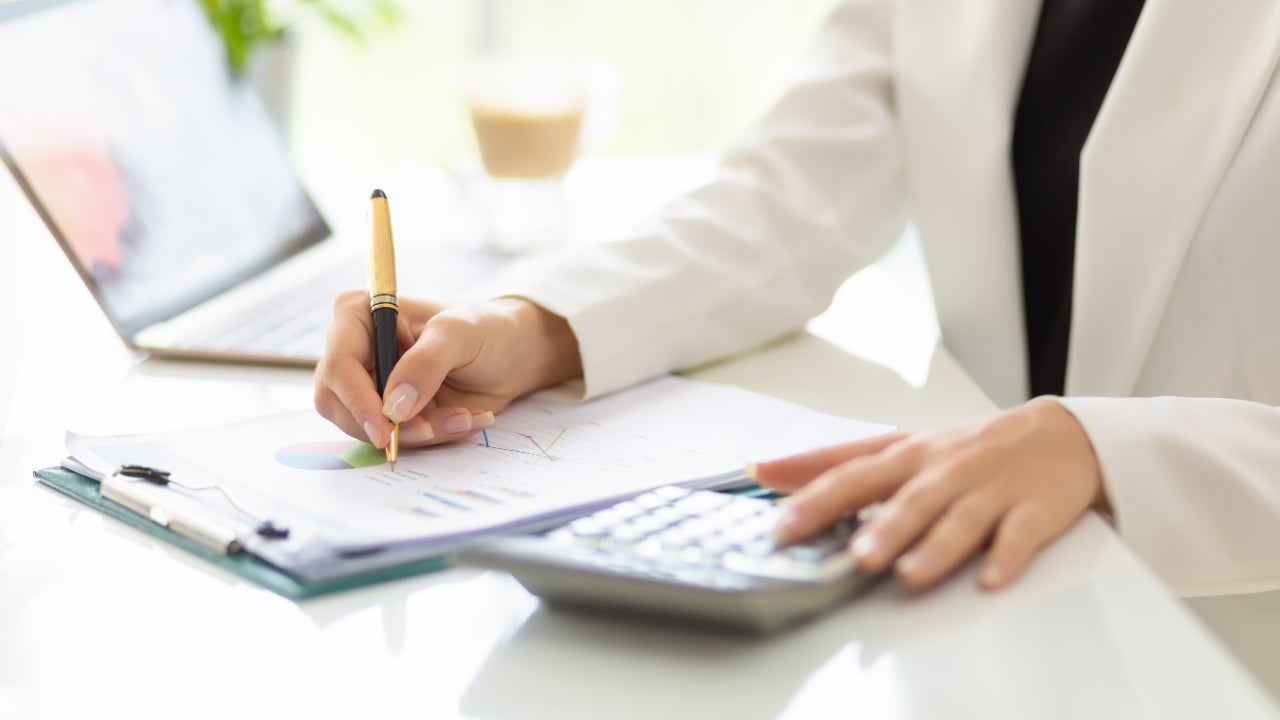 Woman working with business document and laptop on the table