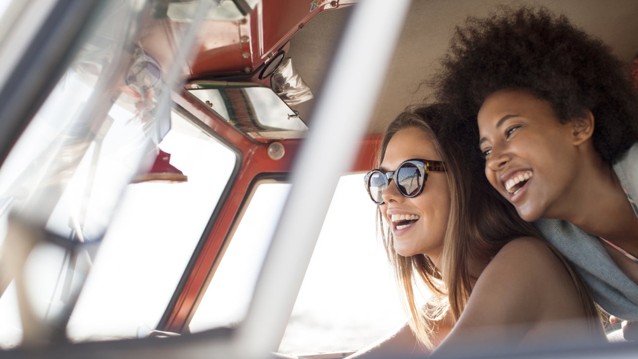 A black woman and her friend are enjoying a nice drive!