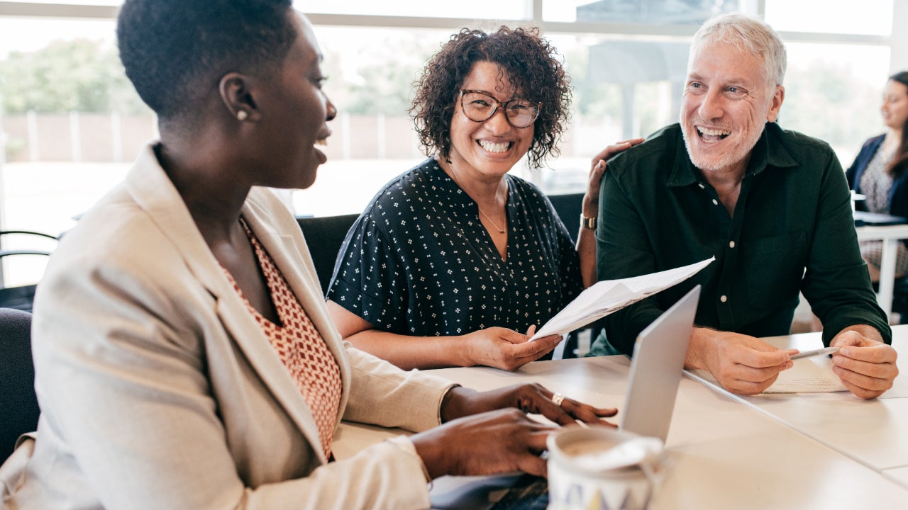 A couple speaks with a financial advisor.