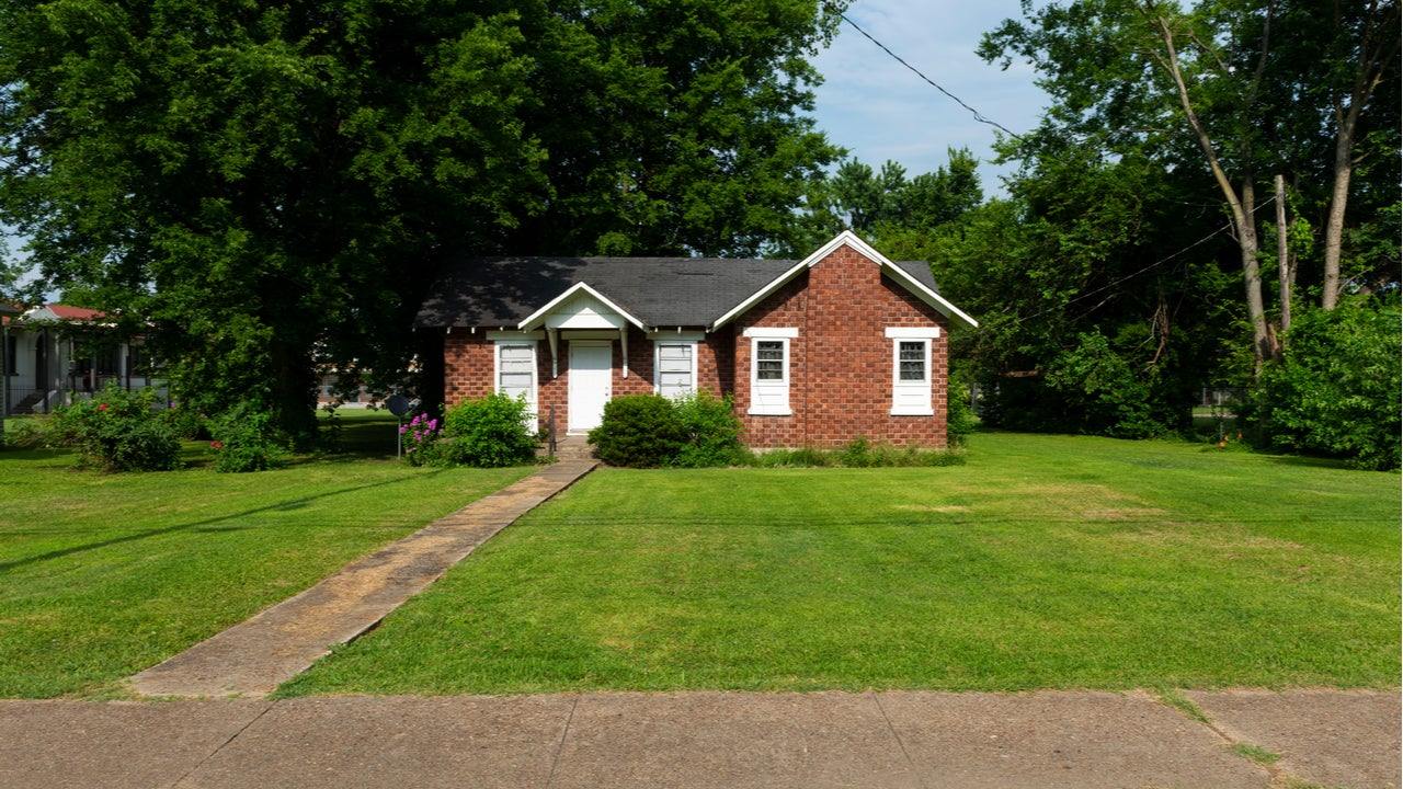 A small single-family, one-story home set back from the road