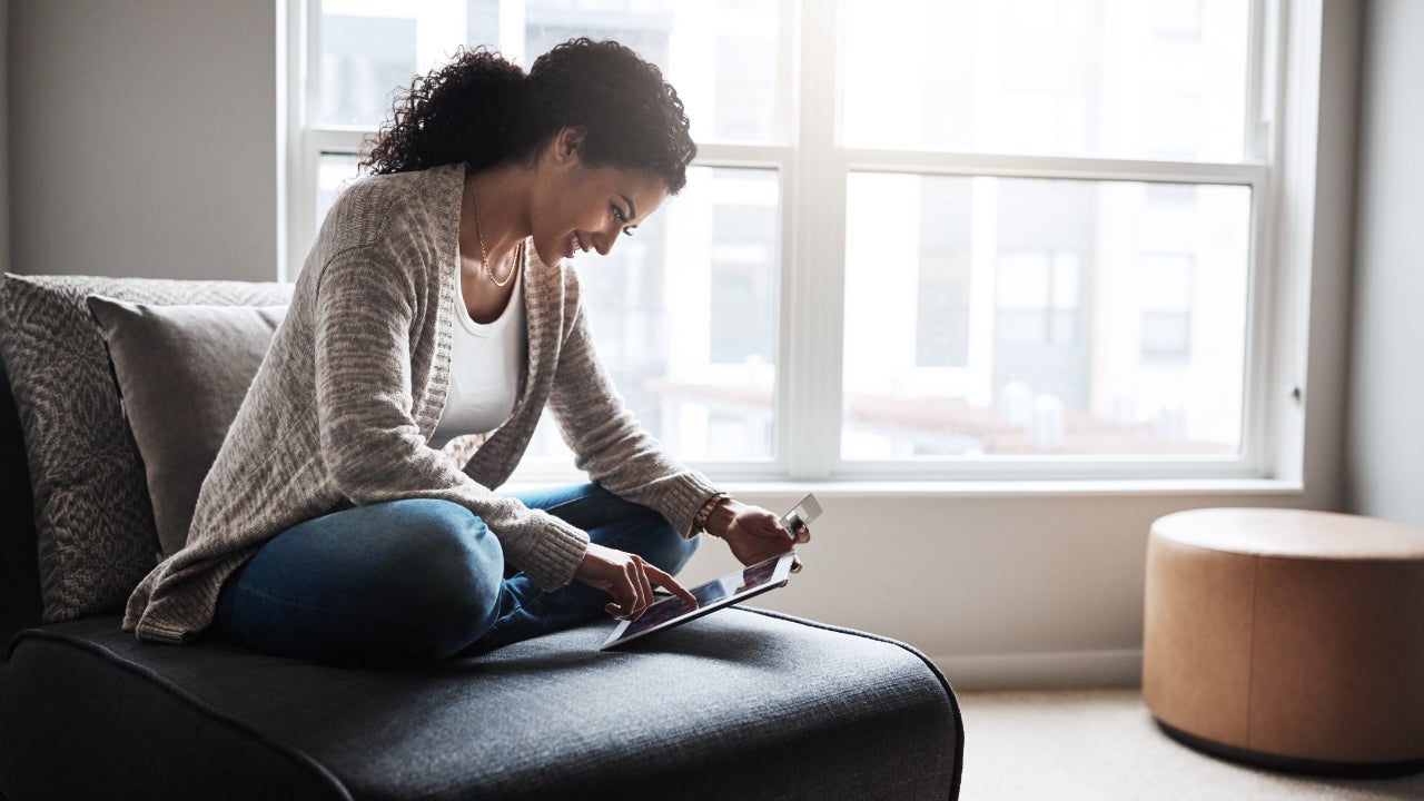 Person looking at tablet and credit card