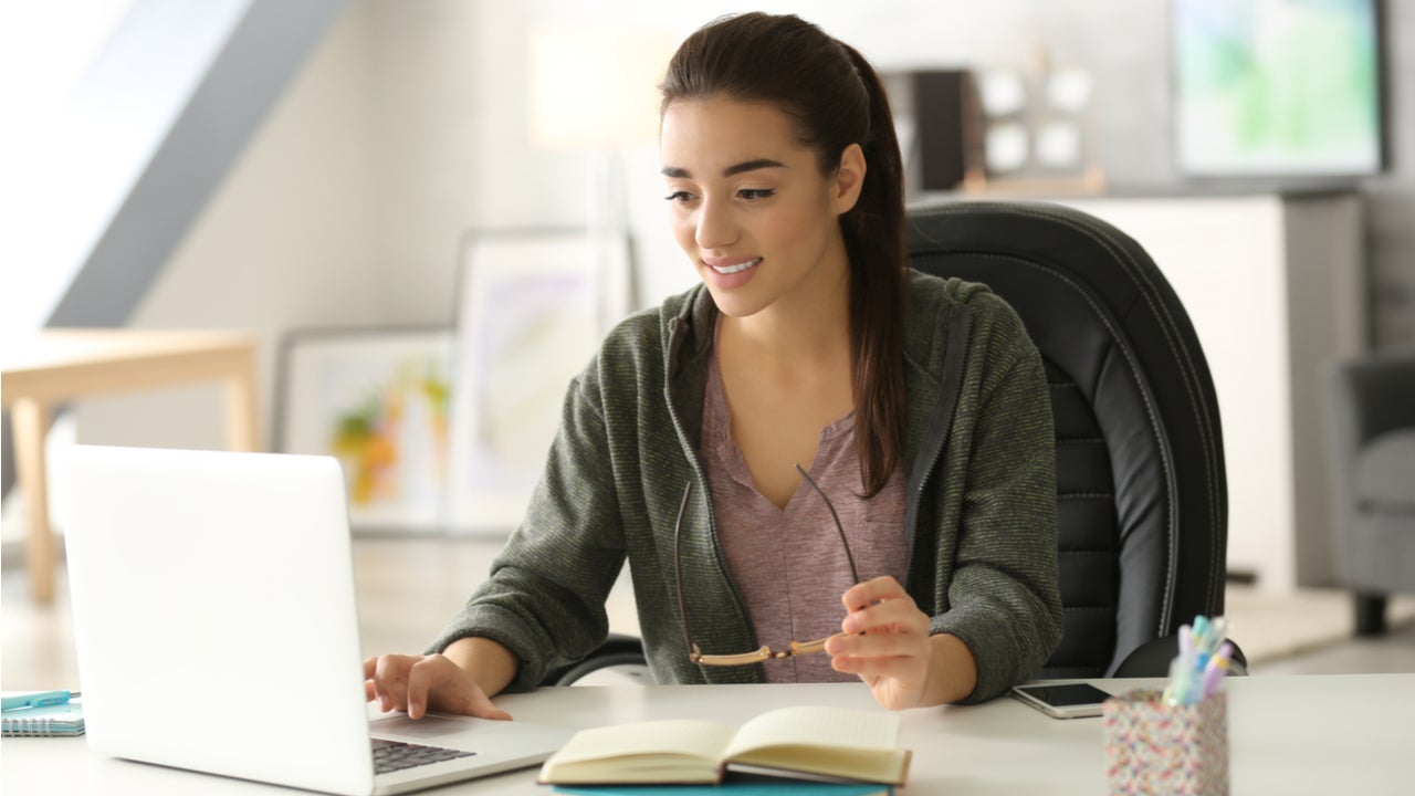 High school student works on laptop