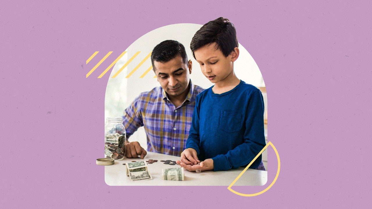 Father and son counting and organizing money (presumably the child's savings)