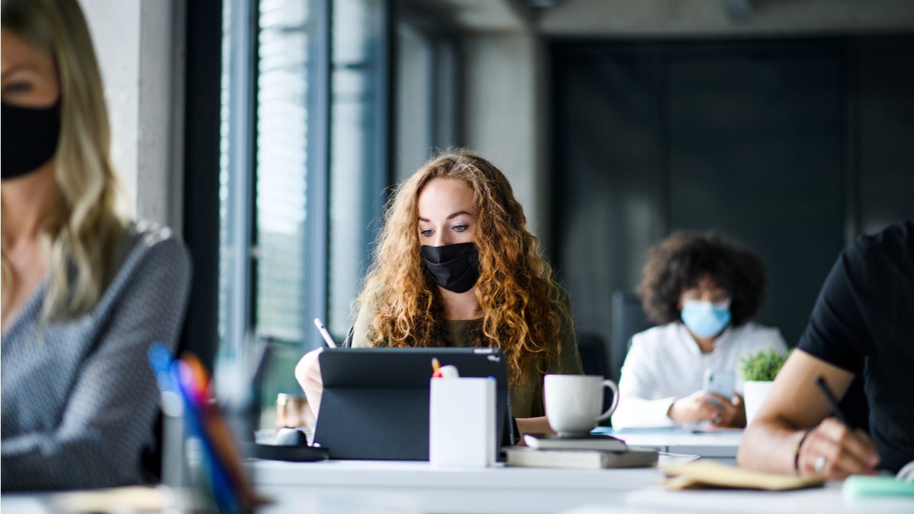 Woman studies while wearing mask