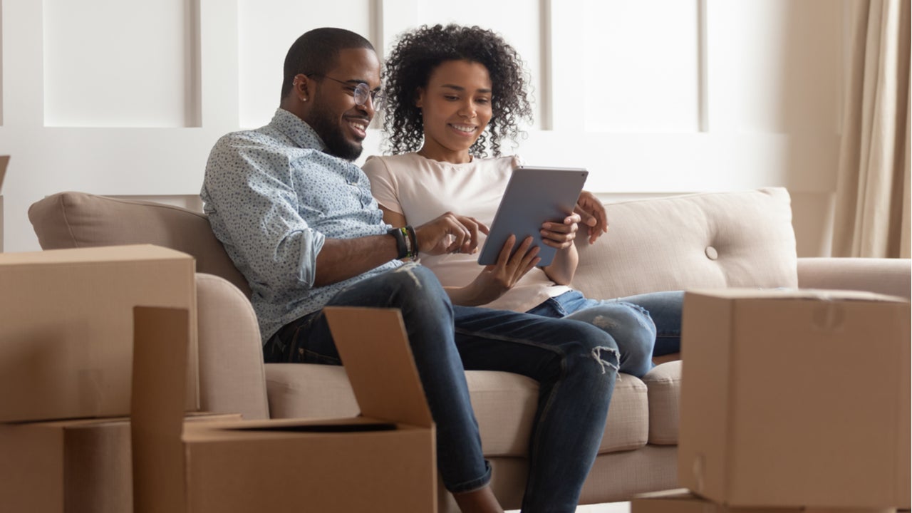 Couple sits on the couch in their new home