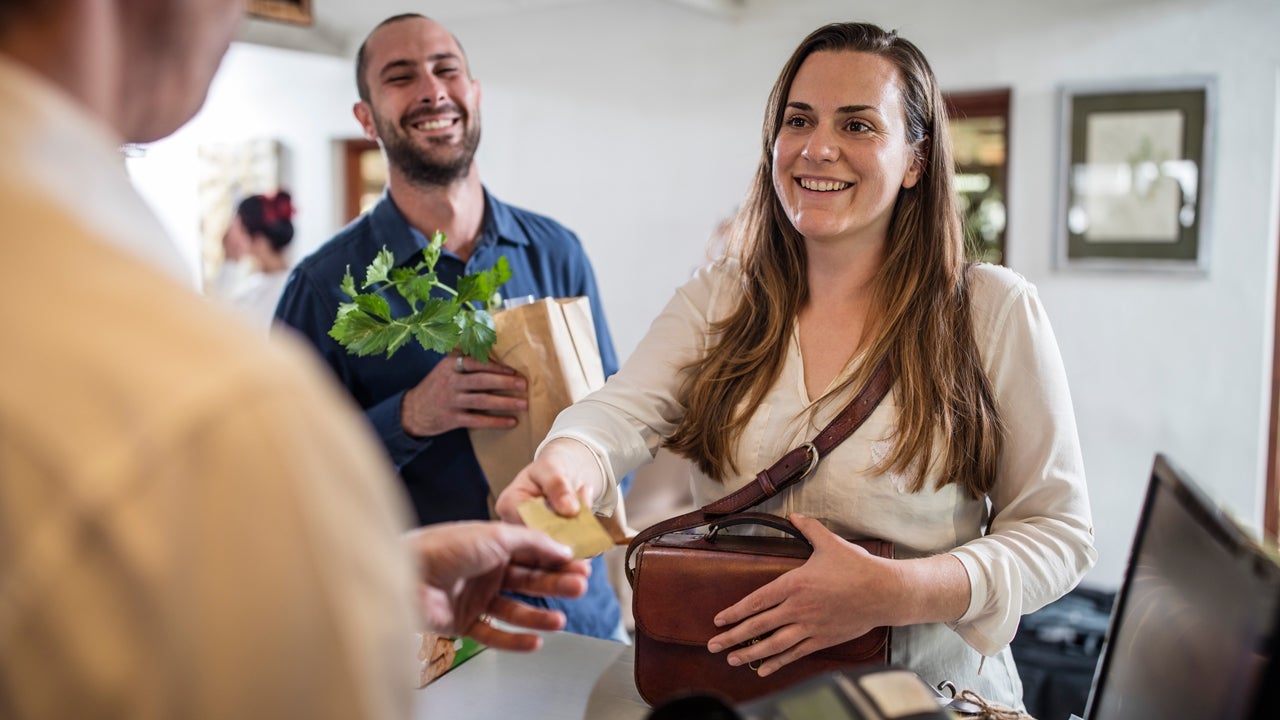 woman paying at counter with credit card