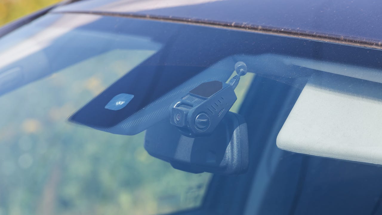 Premium Photo  Hand of technician installing front camera car recorder on  windscreen car