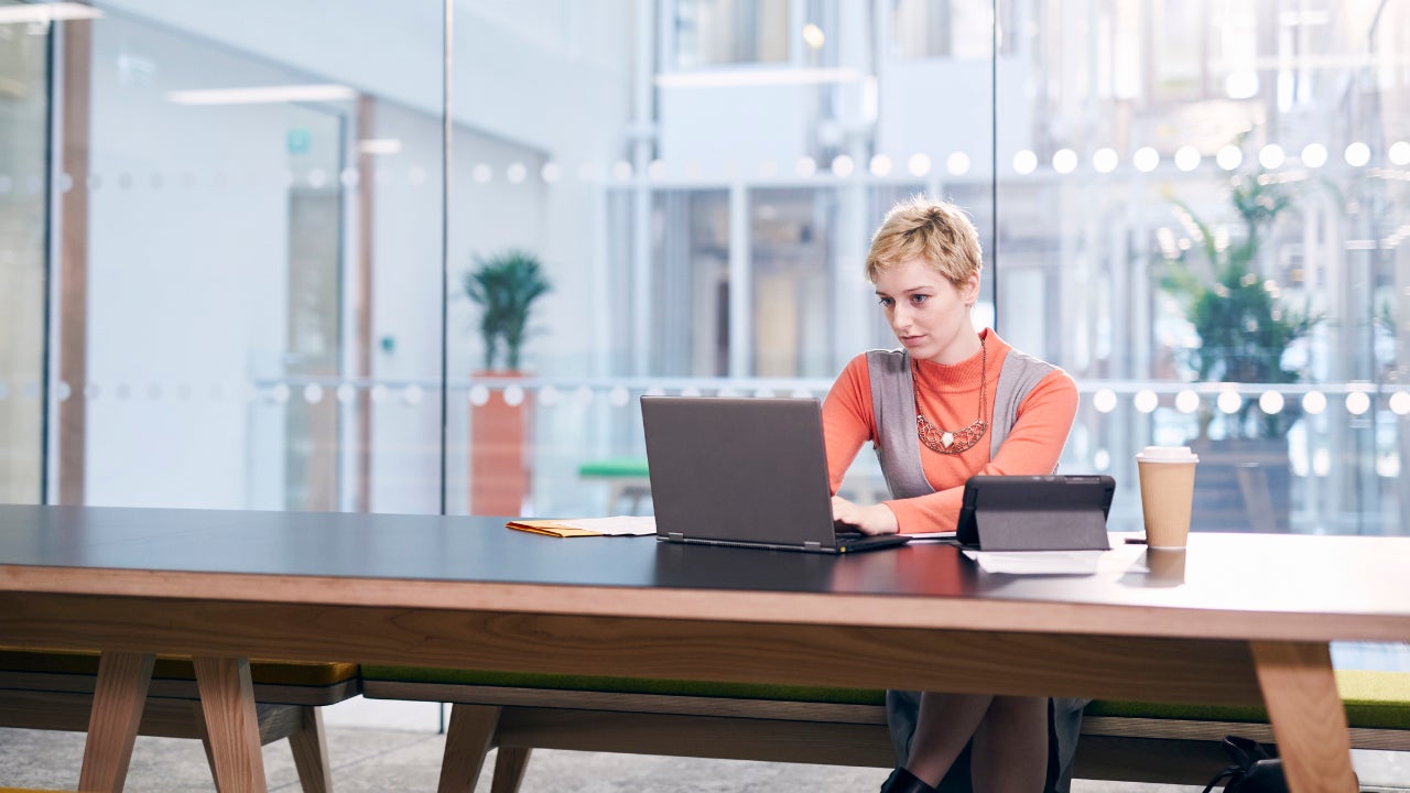 Woman in laptop in corporate building