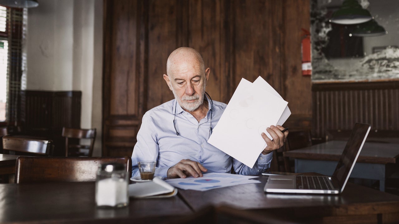 man looking through papers