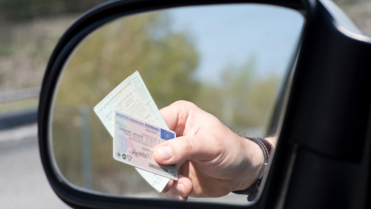 A Man shows Driver's License and Vehicle License during a Check