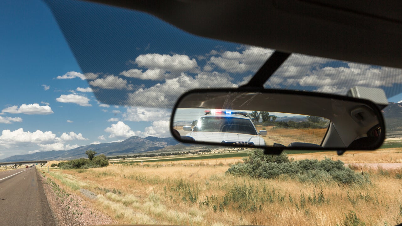 Police pulling over vehicle on the street