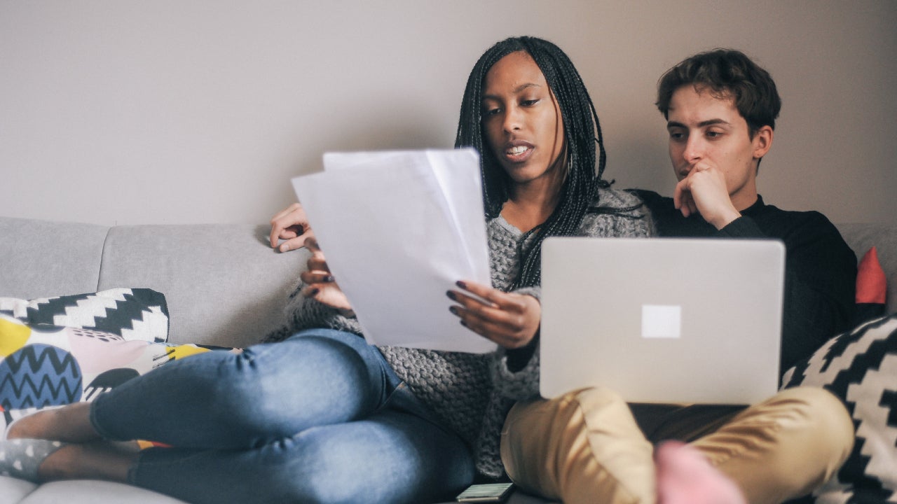 Young couple at home planning an investment