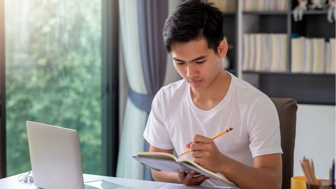 Man looks over notes in a notebook