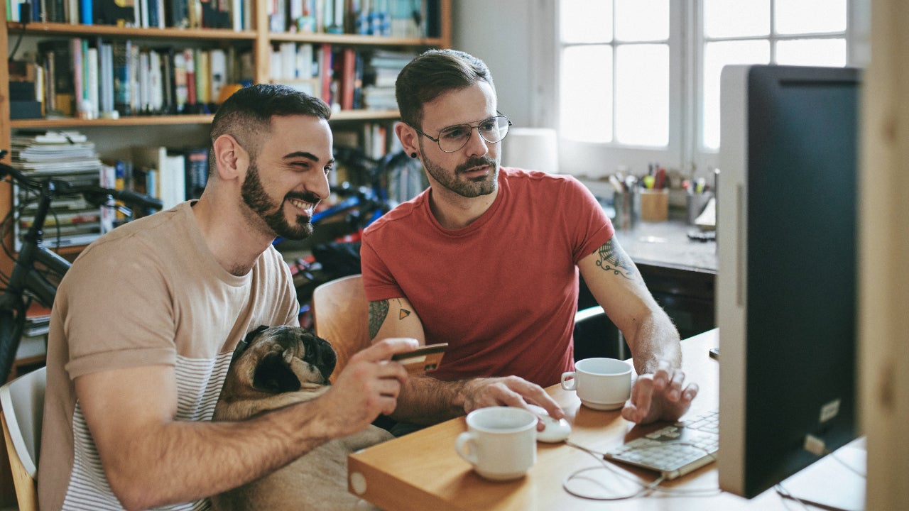 Couple sitting at computer looking at credit cards