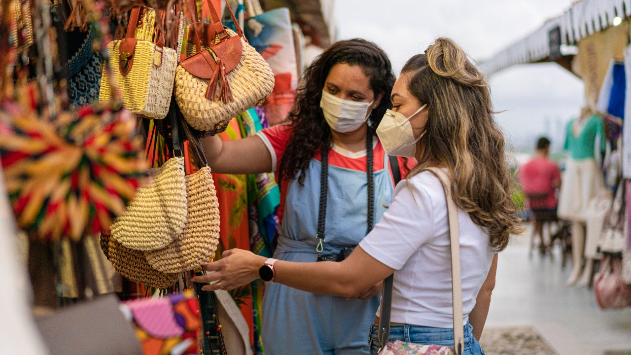 Two young women at open air market