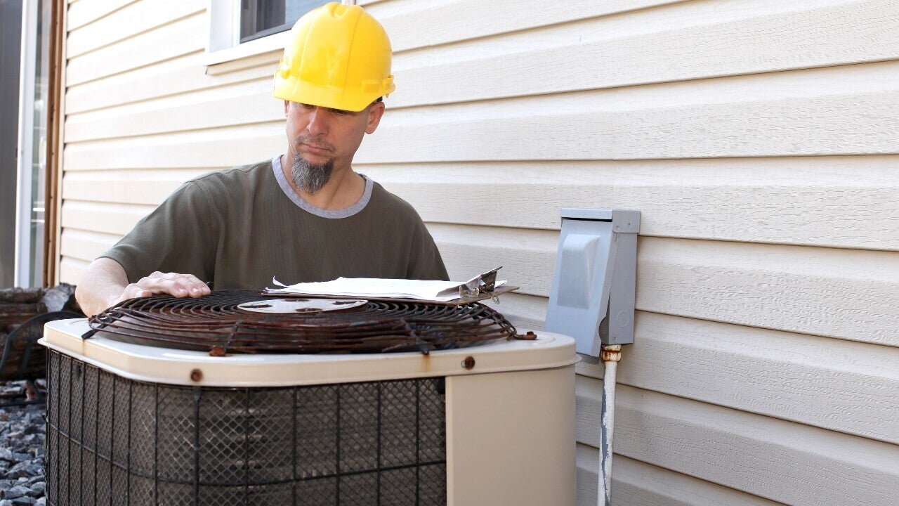 A A/C technician tests a new install