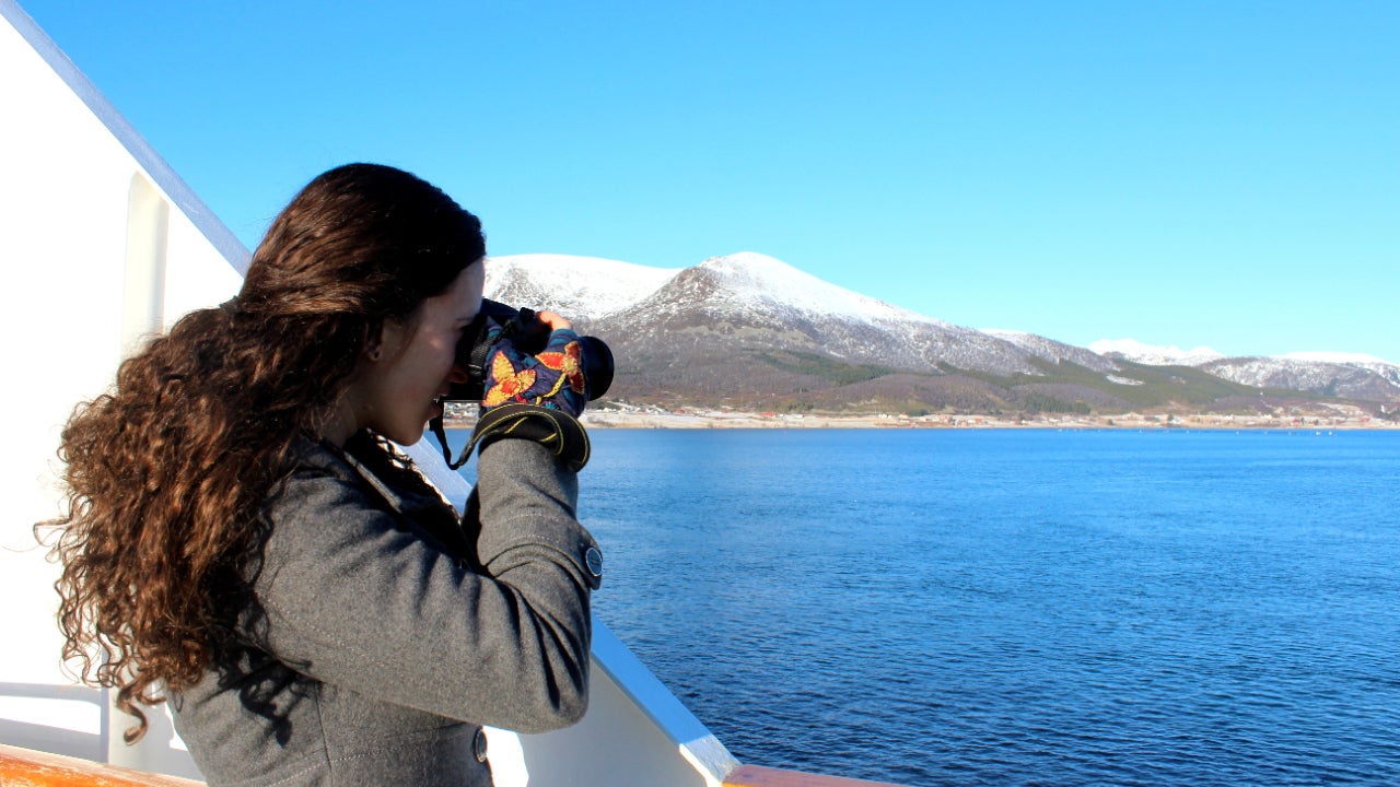 Woman on cruise taking photographs