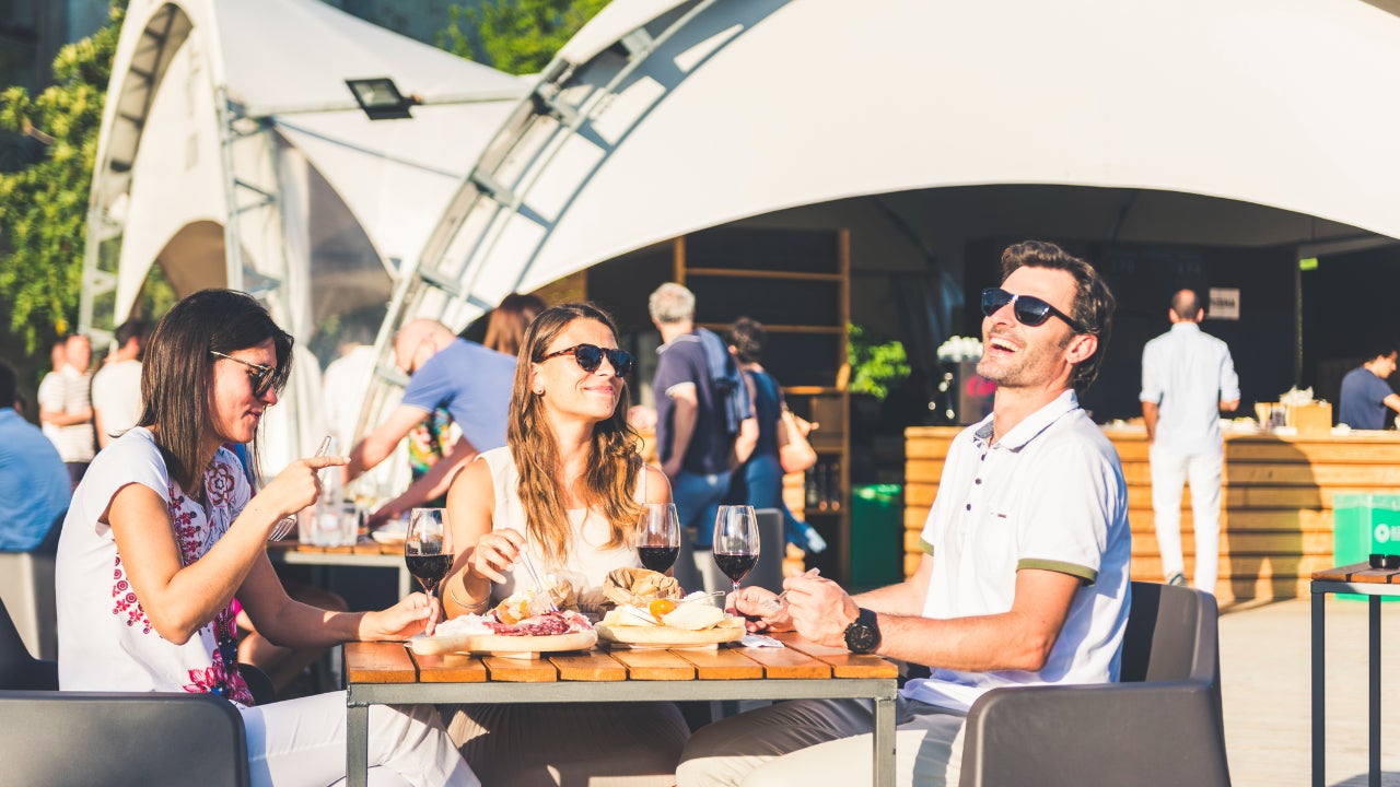 Friend eating at outdoor restaurant in Italy