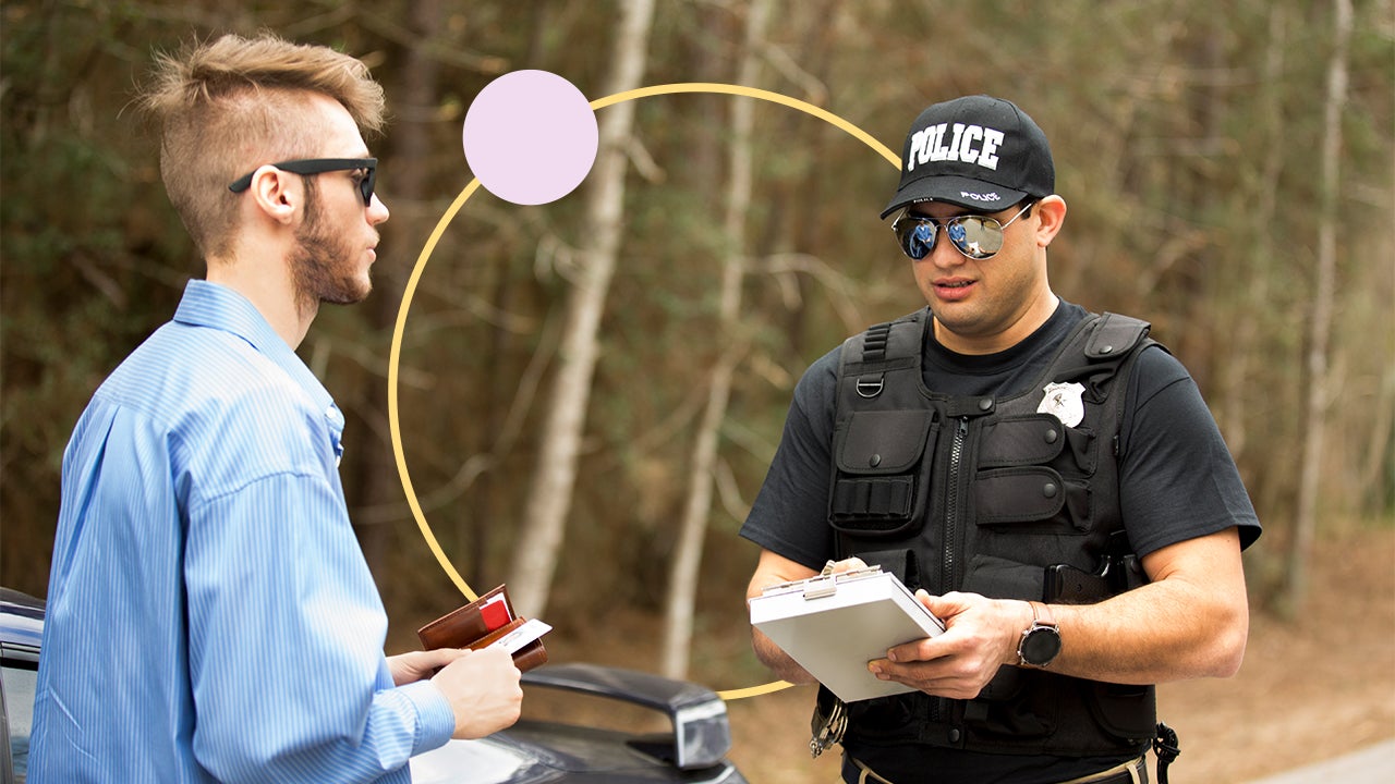 A police officer writing a driver a speeding ticket.