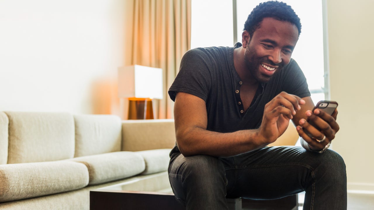 Man using cell phone in living room