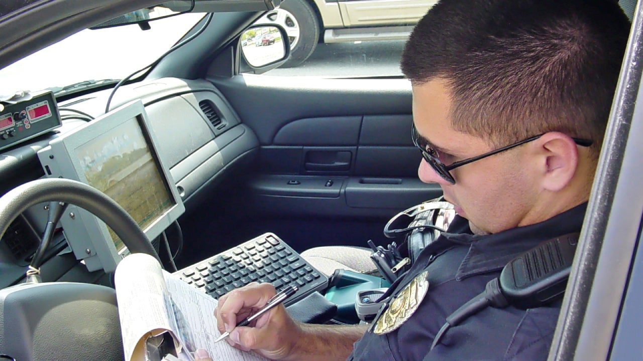 Police officer writing ticket