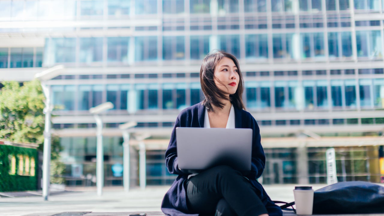 Confident Businesswoman Working With Laptop In The Financial District