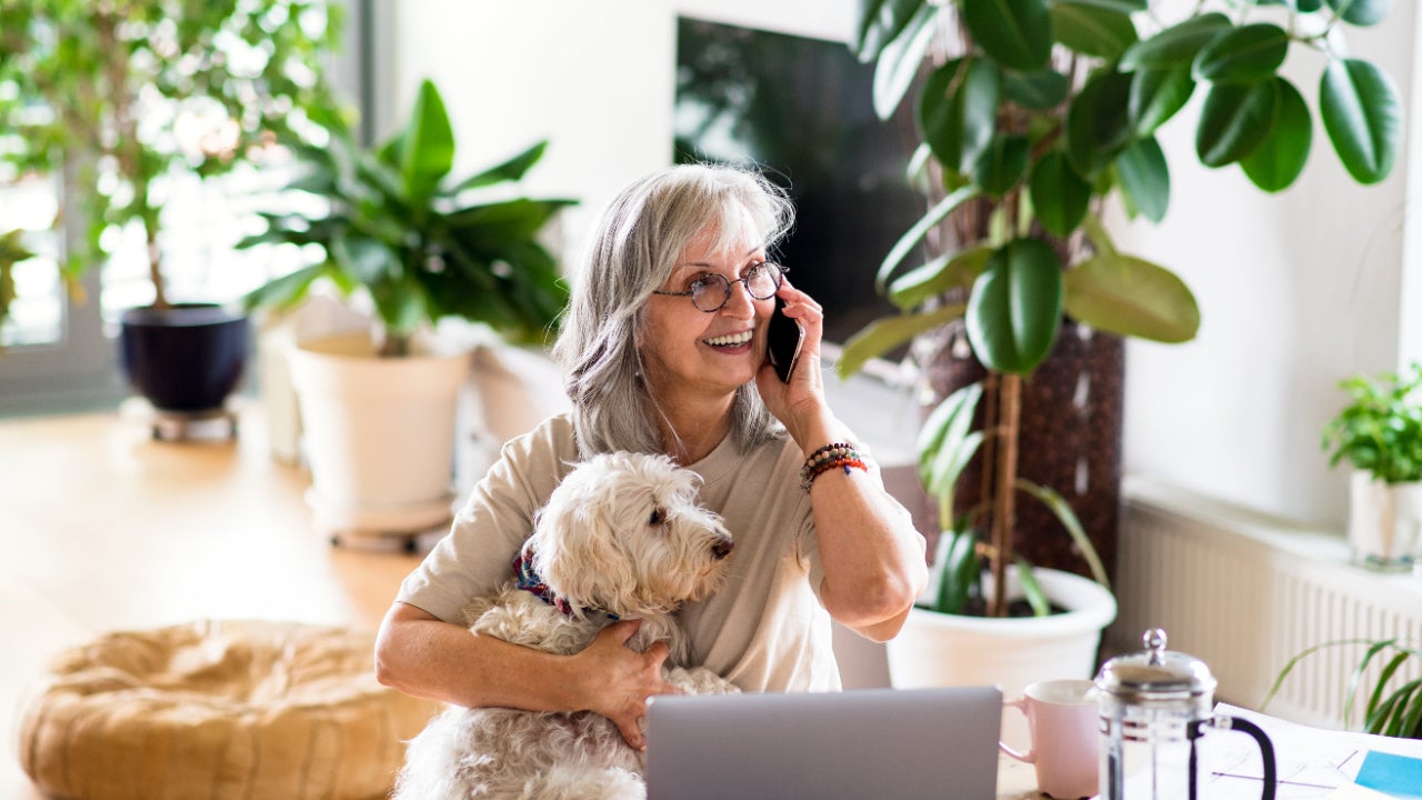 Woman on cell phone with dog