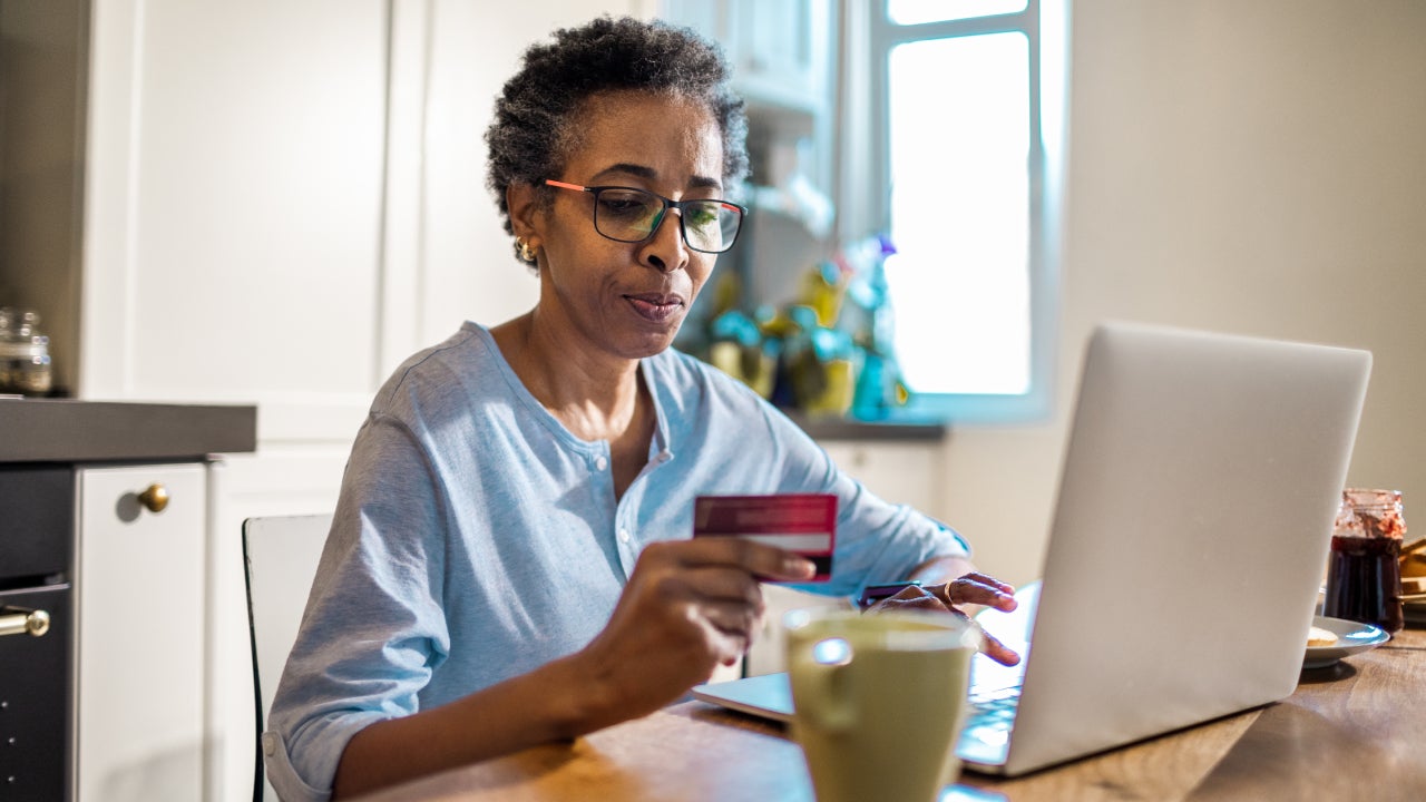 Close up of a senior woman online shopping on her laptop