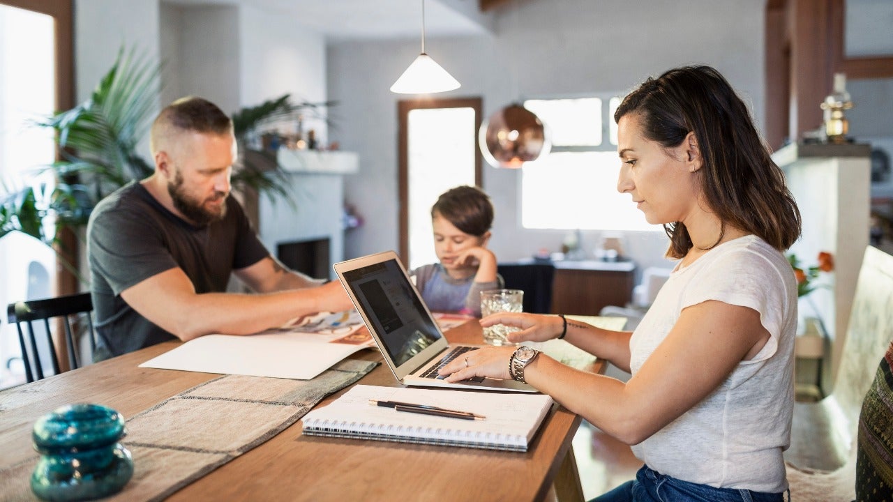 Family sits around a table working